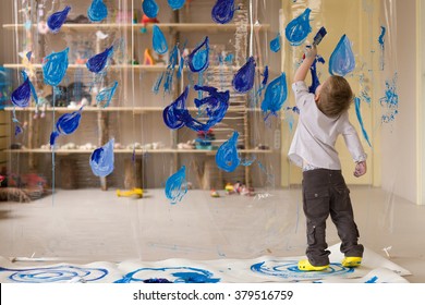 A 3 Years Old Boy In A White Shirt Is Drawing Blue Drops Of Rain. Interesting And Creative  Kids Activities At Home. Spring Leisure Activities For Children Indoors.