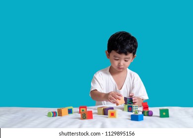 3 Years Old Little Cute Asian Boy Play Toy Or Square Block Puzzle At Home On The Bed, Kid Lying Learn By Playing Block Shape Or Pieces, Education And Healthy Concept.