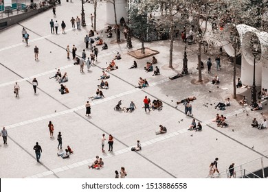30 July 2019, Paris, France: Crowds of tourists resting on a city square near Pompidou Center
