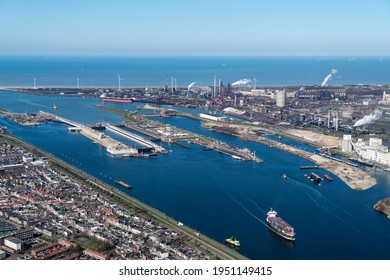 30 March 2021, IJmuiden, Holland. Aerial view of new sluice, Zeesluis IJmuiden with tata steel and a blue clear horizon with North Sea and some ships.