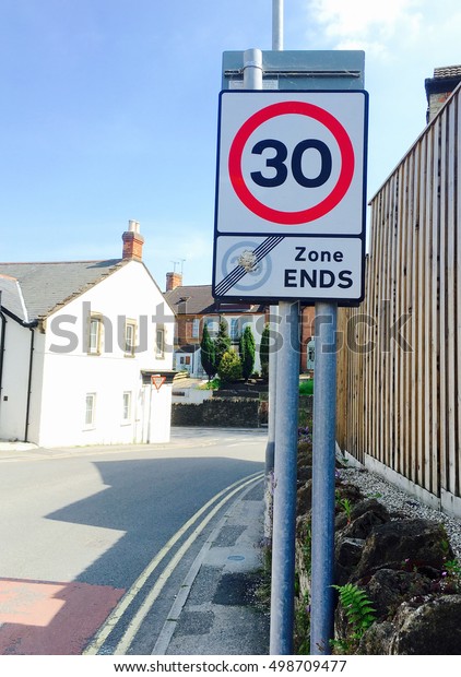 30\
road limit and 20 zone ends signs post on a road in\
UK