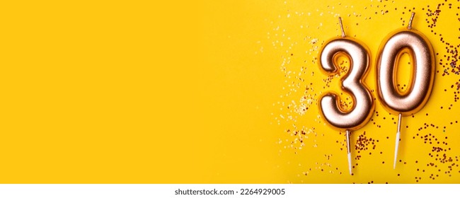 30 years celebration. Greeting banner. Gold candles in the form of number thirty on yellow background with confetti.