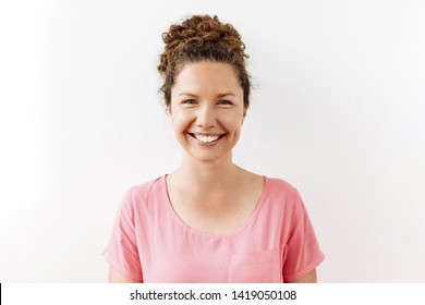 30 Years Curly Woman Portrait Against White Background. Laughter And Joy Emotions