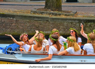 30.08.2019. Group Of Young Women Dressed In White Is Having Fun And Celebrating Bachelorette Party In A Boat On Water Canals In Amsterdam, Netherlands