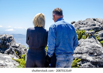 30.11.2021 Cape Town - A Mature Couple Standing On Top Of Table Mountain Enjoying The View Over Cape Town CBD