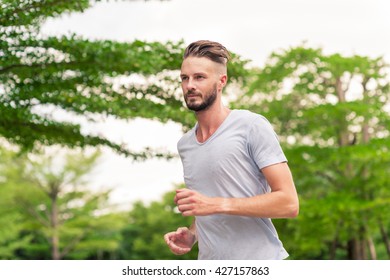 30-35 Year Old Caucasian Male Jogging In The Park