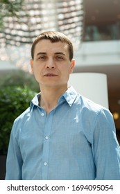 A 30-35 Year Old Man In A Blue Shirt. Portrait Of An Adult Caucasian Man With A Blue Shirt.