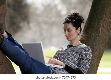 30-35 Years Old Beautiful Woman Portrait Working On Laptop Computer Natural In Park