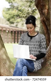 30-35 Years Old Beautiful Woman Portrait Working On Laptop Computer Natural In Park