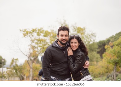 30-40 Years Old Couple In Park Posing For A Photo