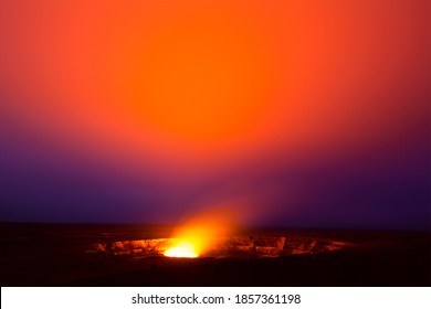 A 30-minute exposure at 3am of the glowing lava lake in the caldera of Hawaii's Kilauea Volcano bounces light off of the haze drifting by in the sky. 