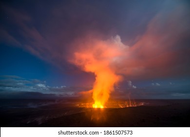 A 30-second captures the glowing lava lake in the caldera of Hawaii's Kilauea Volcano as it bounces light off of the haze drifting by in the sky. - Shutterstock ID 1861507573