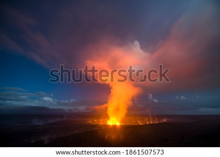 A 30-second captures the glowing lava lake in the caldera of Hawaii's Kilauea Volcano as it bounces light off of the haze drifting by in the sky.

