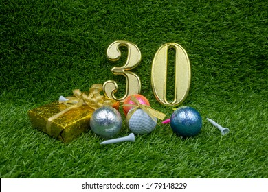 30th Birthday Anniversary With Gifts And Golf Balls Are On Green Grass.