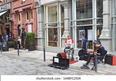 30th June 2019, Dublin, Ireland.  Buskers performing  at the corner of Grafton Street and Harry Street, Dublin city centre, near the Phil Lynott memorial statue and Bruxelles pub. 