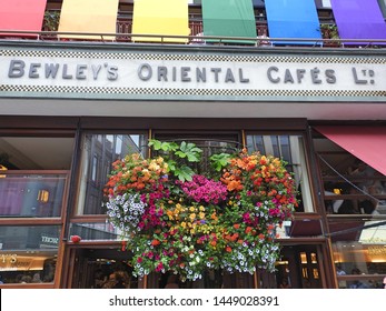 30th June 2019, Dublin, Ireland. The image is of one of Dublin's most popular cafes, Bewley's on Grafton Street, with a flower display hanging outside. 