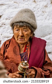 31-03-2016 – 09:09:14 This Old Woman Went Round The Temple And Came To Rotate The Drums While She Is Holding A MINI-DRUM In Her Hand At Bumthang, A Town Of Bhutan  