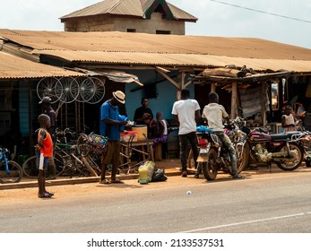 31.12.2021, Ivory Coast - road in the village on the way form Abidjan to Abenguru. Next to the road there are small shops.