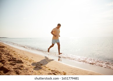 35 Years Old Man Running On The Sandy Beach