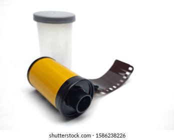 35mm Camera Film Roll With Plastic Film Canister On White Background