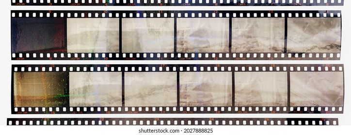35mm positive filmstrips with empty frames, real scan of film material with cool scanning light interferences on the material. retro photo placeholder. - Shutterstock ID 2027888825