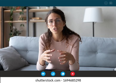 35s female teacher teach by video call explain educational material to trainee distantly seated on couch in living room at home. Friends communicating use videoconference app concept, pc screen view - Shutterstock ID 1694685298