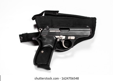 380 caliber black blowback action handgun pistol with clip fully loaded with bullet rounds on top of a clip slide on gun holster isolated on a white background