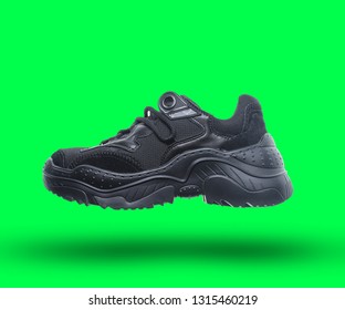 3d Black Sneaker On Green Background. Side View.
