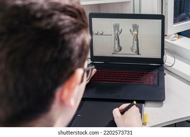 3D designer student uses a graphics tablet to work on a game character. development of 3d characters for online games.