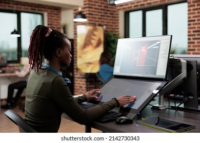 3D digital artist sitting at computer desk while working on environmental design. Creative agency production department team leader developing professional game technology.