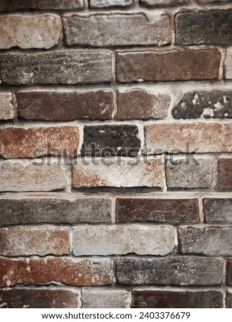 3D Grey-red-brown brick wall of the stone blocks. Textured background