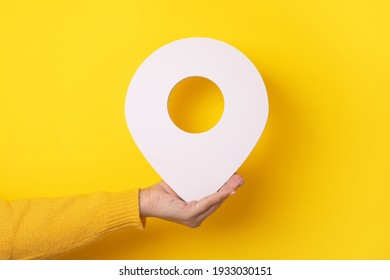 3D Location Symbol In Hand Over Yellow Background