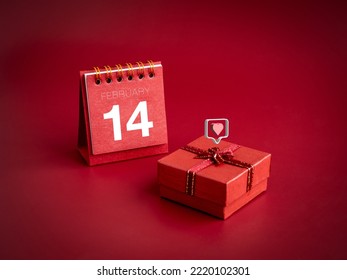 3d love like heart icons floating on small red present gift box with February ,14 Valentine's day on desk calendar cover on red background. Special gift for Valentine's Day, minimal style. - Shutterstock ID 2220102301