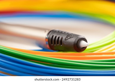 3d pen for creating volume plastic figures isolated on white background. 3d pen, kit of colourful plastic filament on white background