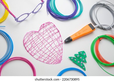 3d Pen. Printing With Colored Plastic Wire Filament. Child Making A Christmas Three, Heart Shape Drawing With 3D Pen. Artwork, Robotics. STEAM, STEM Education. Modern Technologies. Study At Home