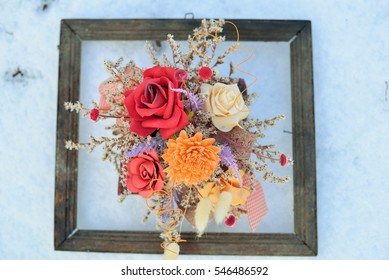 3d Picture In Nature. Dried Flowers In A Very Old Photo Frame On Snow