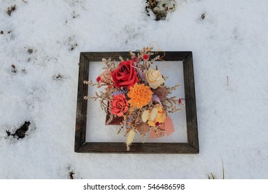 3d Picture In Nature. Dried Flowers In A Very Old Photo Frame On Snow