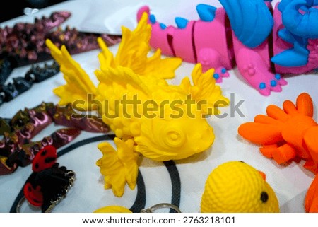 3D printed different art objects. Objects printed on 3D printer from melted colored plastic. Model yellow fish created on 3D printer from threads of molten plastic. Modern new additive technologies