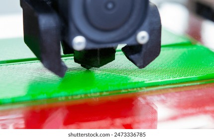 3D printer close up. Working 3D printer close-up. The process of printing on a 3D printer. 3D printer creating an object from molten plastic.