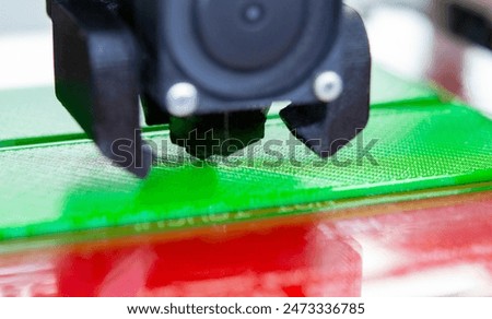 3D printer close up. Working 3D printer close-up. The process of printing on a 3D printer. 3D printer creating an object from molten plastic.
