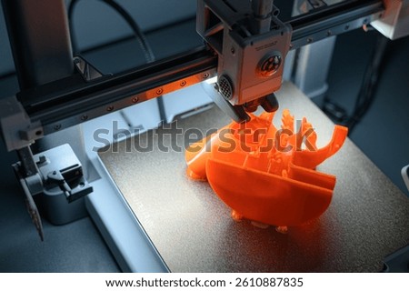 3D Printer Creating Vibrant Orange Prototype Model