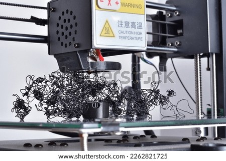3D printer fail. Plactic filament extruded randomly. Curled black PLA not bonded to printed part. Warning Caution high temperature