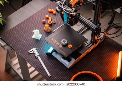 3D printer in the laboratory top view, 3D printer in the process. 3d printer close-up blue and orange backlight. High quality photo