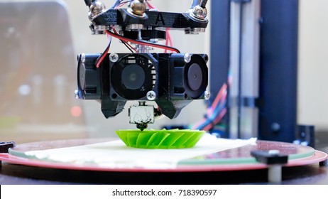 3D printer performs product creation. Modern 3D printing or additive manufacturing and robotic automation technology. Three dimensional printing is a new era in industrial design and production.