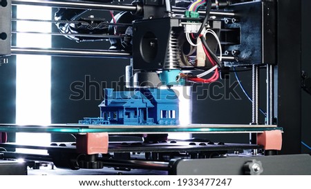 3d Printer printing blue house