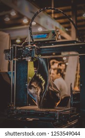 3D printer printing a model in the form of black vase close-up. The concept modern additive technology. The 4ht industrial revolution.