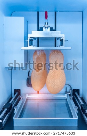 3D printer prints the form of plastic. Automatic three dimensional 3d printer performs plastic modeling in laboratory.