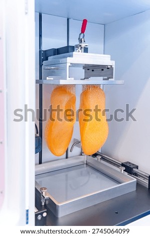 3D printer prints the form of plastic. Automatic three dimensional 3d printer performs plastic modeling in laboratory.