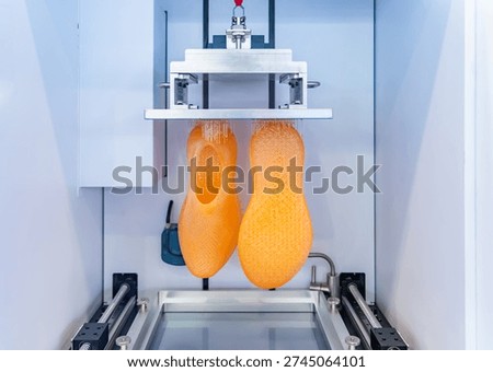 3D printer prints the form of plastic. Automatic three dimensional 3d printer performs plastic modeling in laboratory.