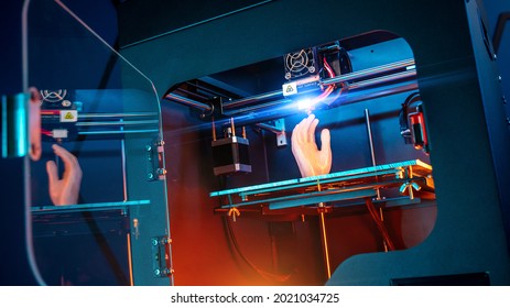 3d printer prints a hand. 3d printer at work, advertising photo blue and orange backlight. High quality photo